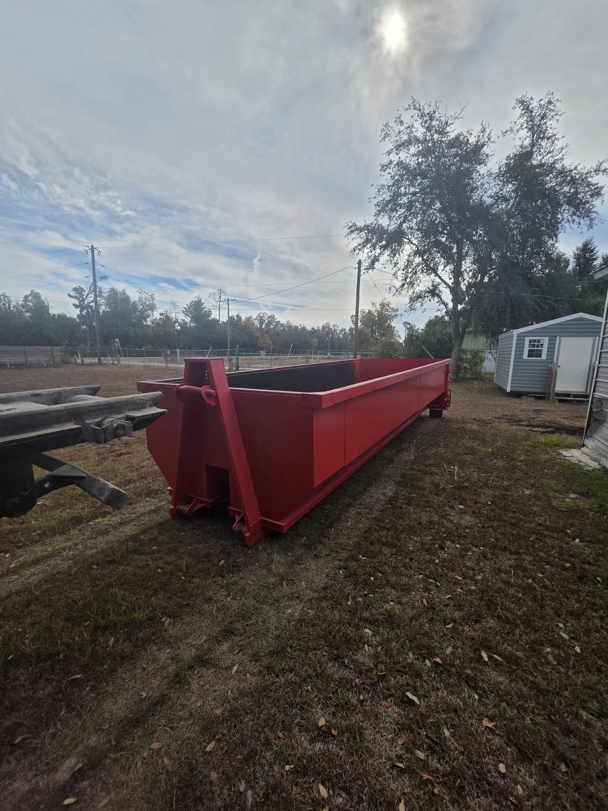 Muckpro roll-off dumpster delivered to a rural property in Day FL