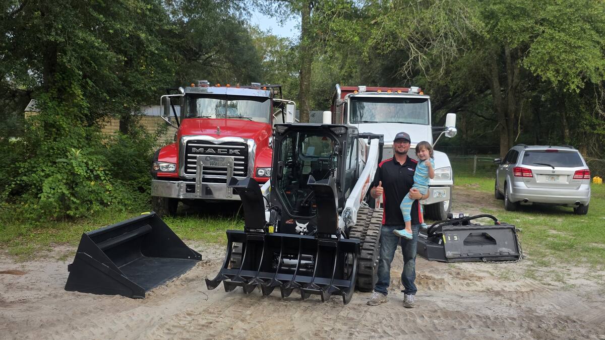 Muckpro founder Darrell Sparks and his son with the new Bobcat T66 at the Live Oak yard