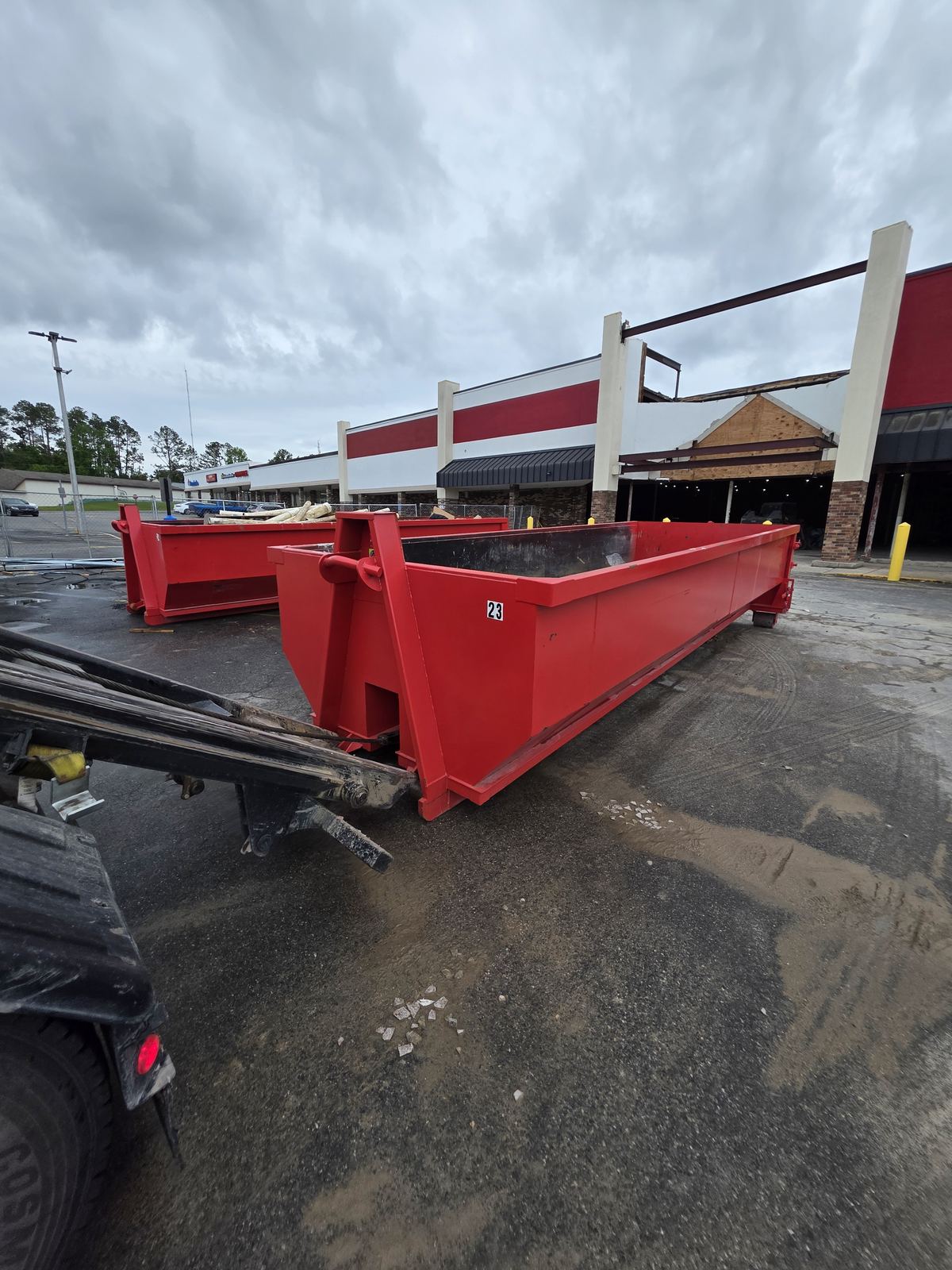 Two Muckpro roll-off dumpsters staged at a commercial demolition in Madison FL