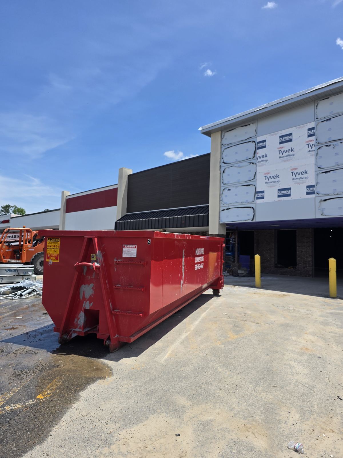 Muckpro roll-off dumpster at a Madison FL storefront renovation