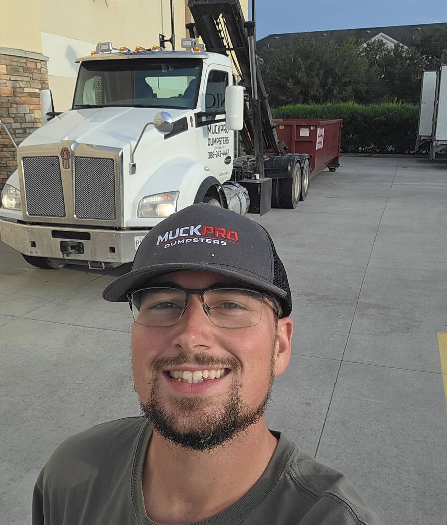 Darrell Sparks, Muckpro owner, in front of the Kenworth on an evening emergency dumpster delivery in Gainesville