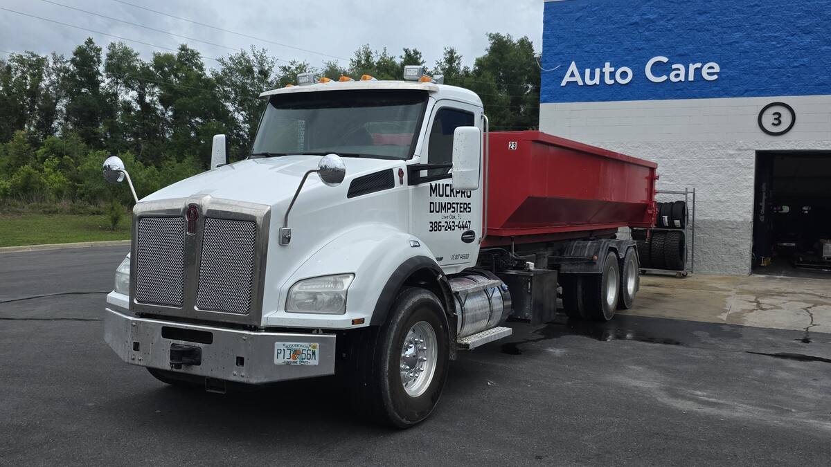 Muckpro truck servicing a commercial 20-yard dumpster in Perry, Florida