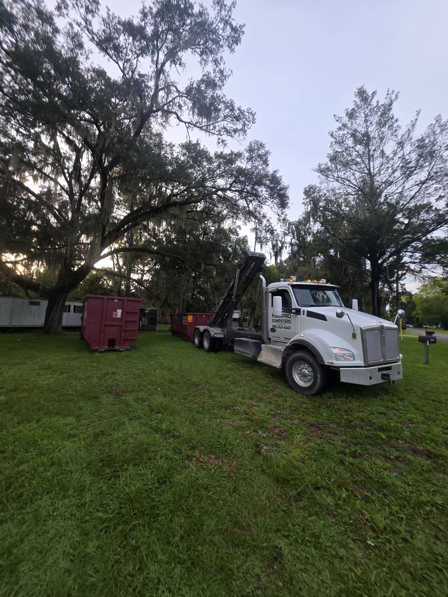Muckpro roll-off truck delivering dumpsters in Williston FL