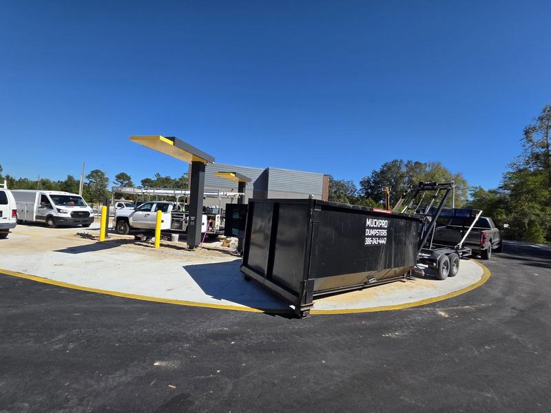 Muckpro roll-off dumpster at a new commercial drive-thru build in High Springs FL