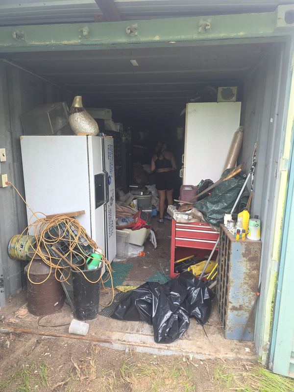 Storage container full of furniture and appliances before junk removal
