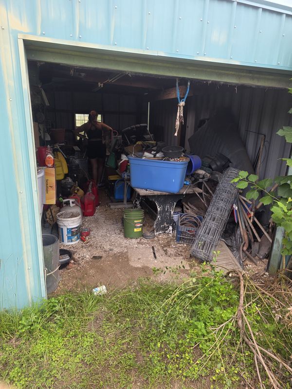 Equipment shed packed with clutter before Muckpro junk removal in North Florida